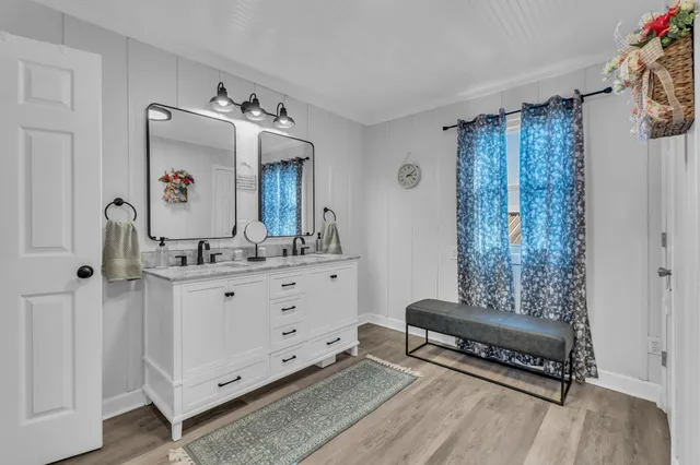 a bathroom with a double vanity sink mirror and shower