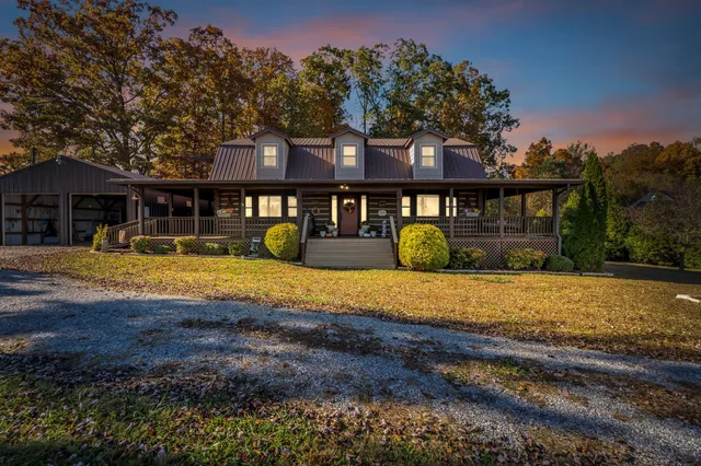 a view of a house with backyard and swimming pool