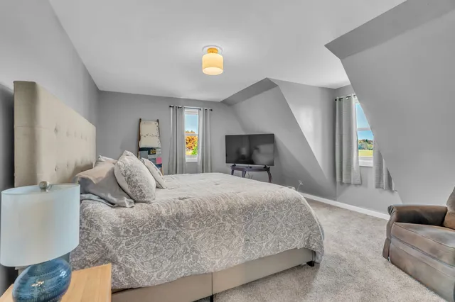 a bedroom with a large bed and a couch