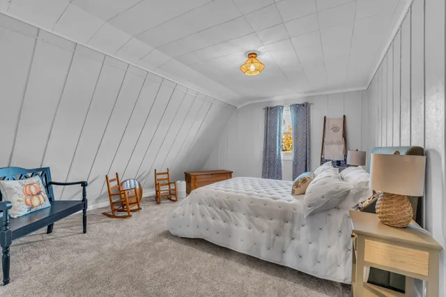 a bedroom with furniture and a window