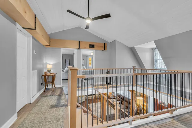 a view of a balcony with wooden floor and furniture