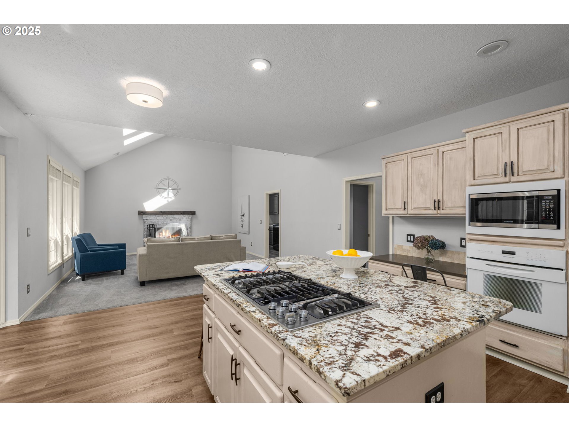 6783 Apollo Road West Linn, OR 97068 - Photo 11 of 42 a kitchen with kitchen island a stove sink and microwave