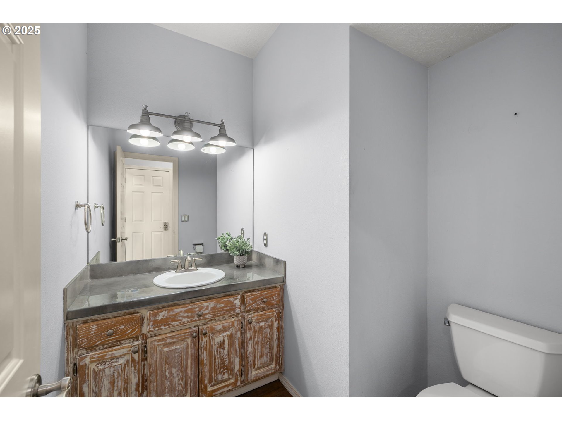 6783 Apollo Road West Linn, OR 97068 - Photo 16 of 42 a bathroom with a granite countertop sink a toilet and a mirror