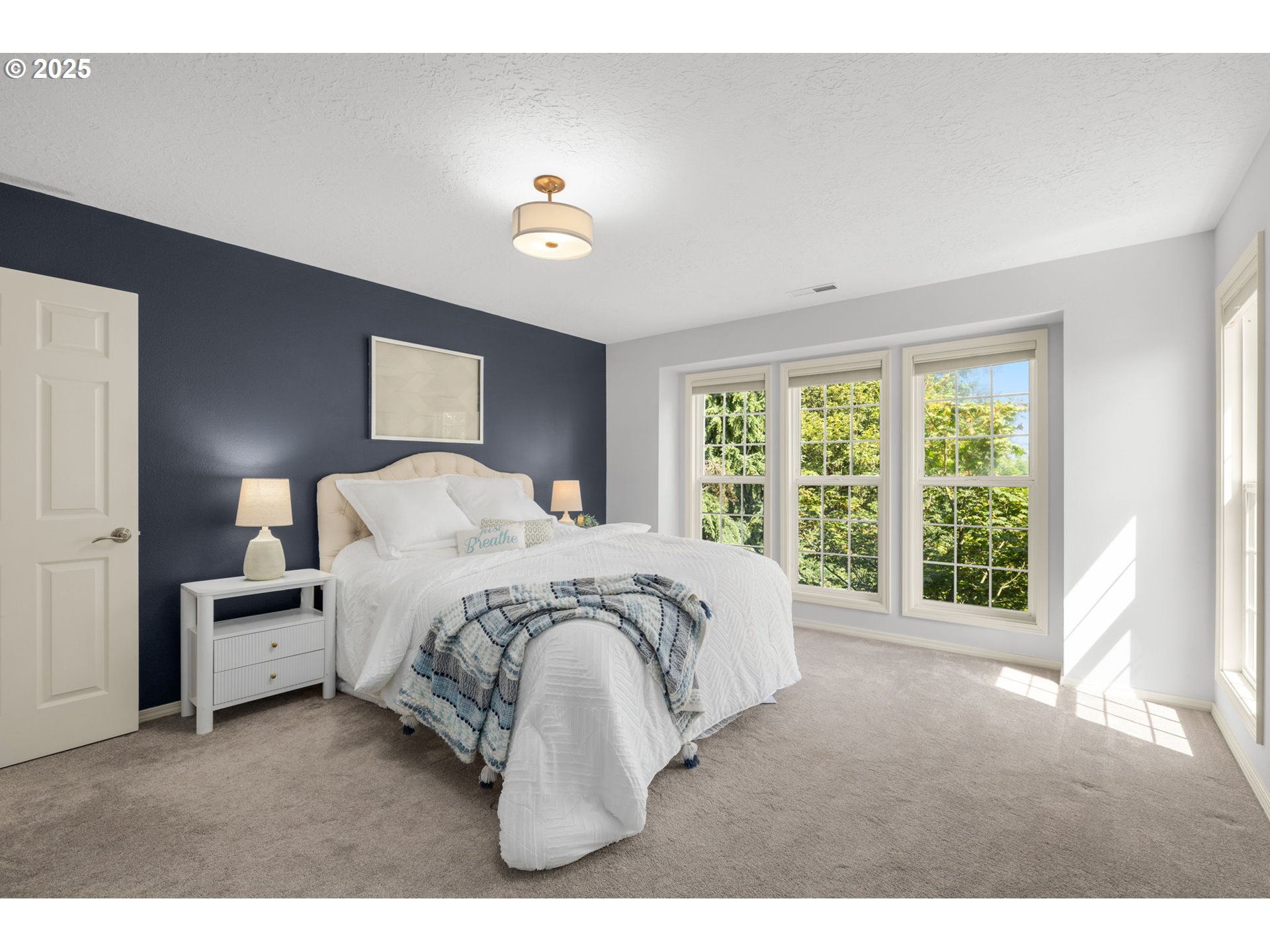 6783 Apollo Road West Linn, OR 97068 - Photo 17 of 42 a spacious bedroom with a bed and a large window