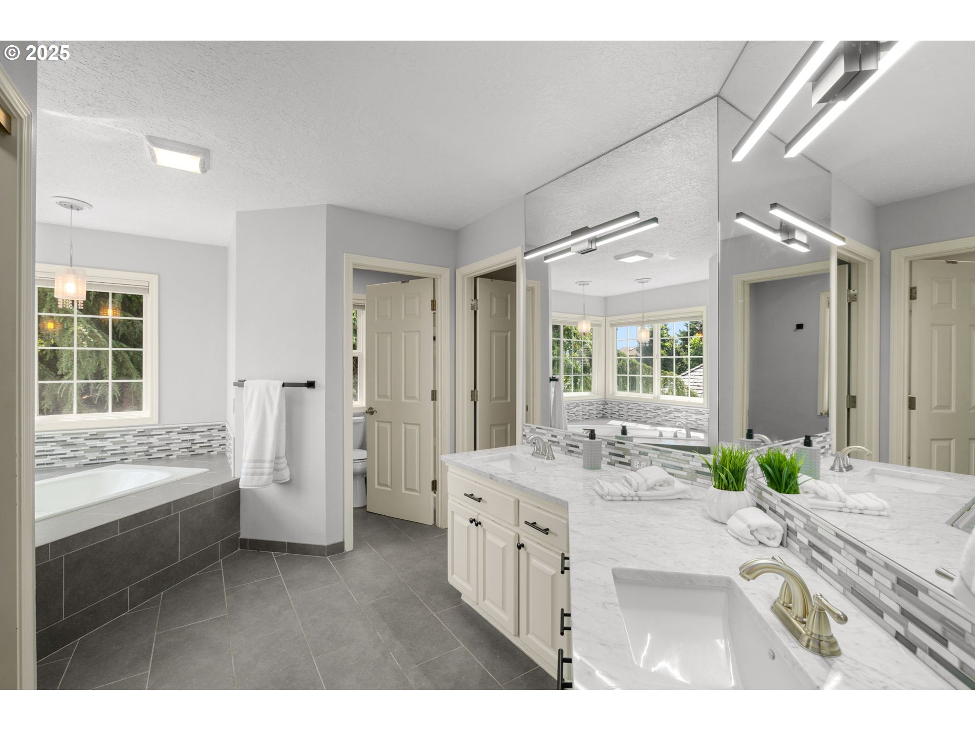 6783 Apollo Road West Linn, OR 97068 - Photo 19 of 42 a bathroom with a granite countertop sink mirror and a bathtub