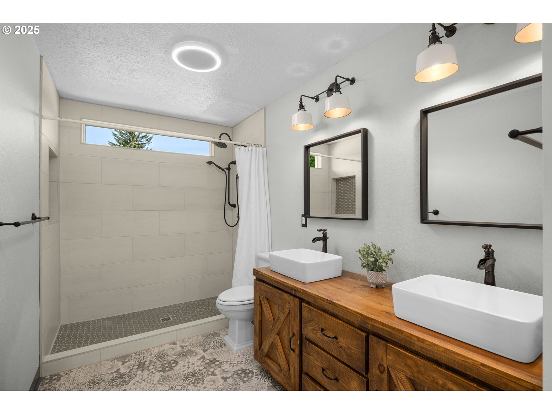 6783 Apollo Road West Linn, OR 97068 - Photo 27 of 42 a bathroom with a double vanity sink mirror and shower