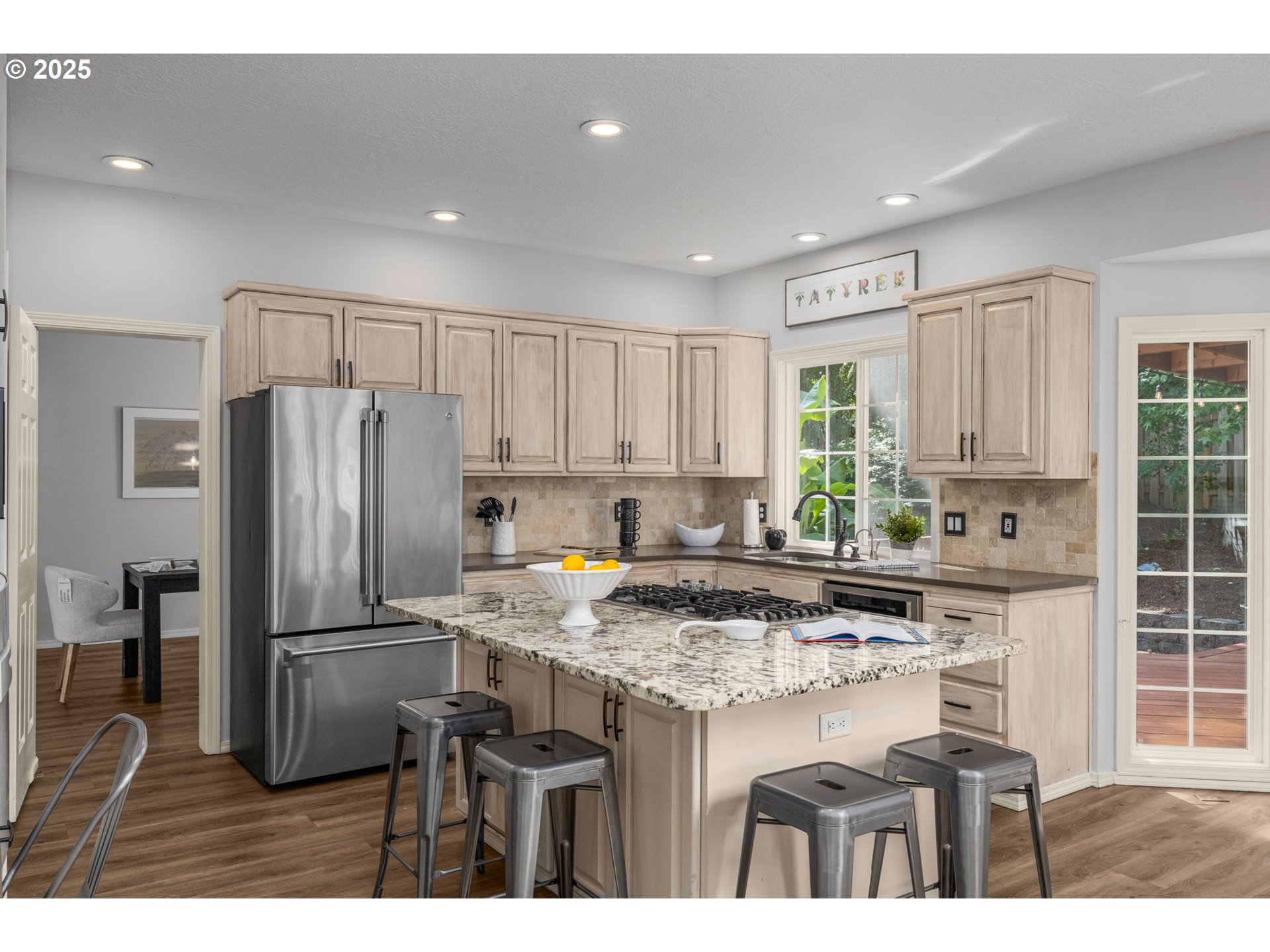 6783 Apollo Road West Linn, OR 97068 - Photo 10 of 42 a kitchen with a table chairs refrigerator and microwave