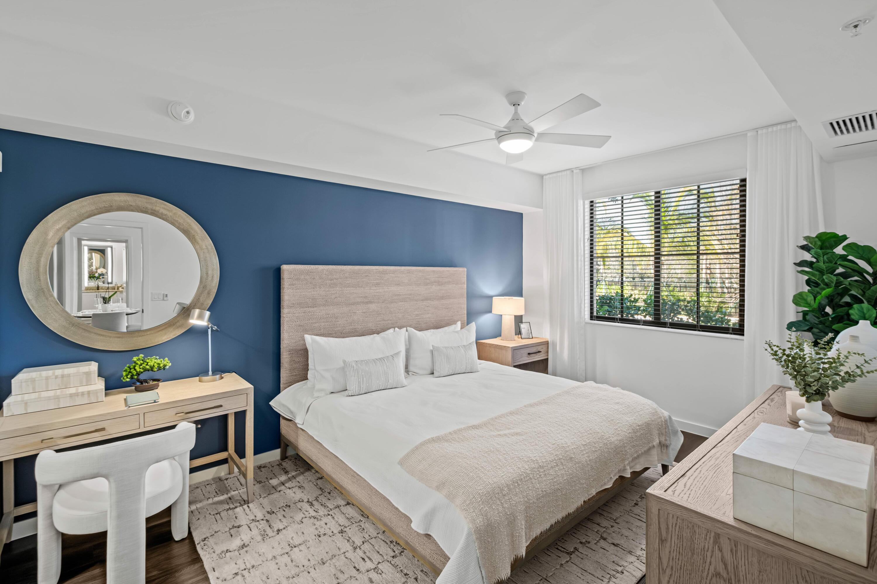 2000 Stirling Road, Unit 14103 Hollywood, FL 33020 - Photo 19 of 35 a bedroom with a large bed and a chandelier