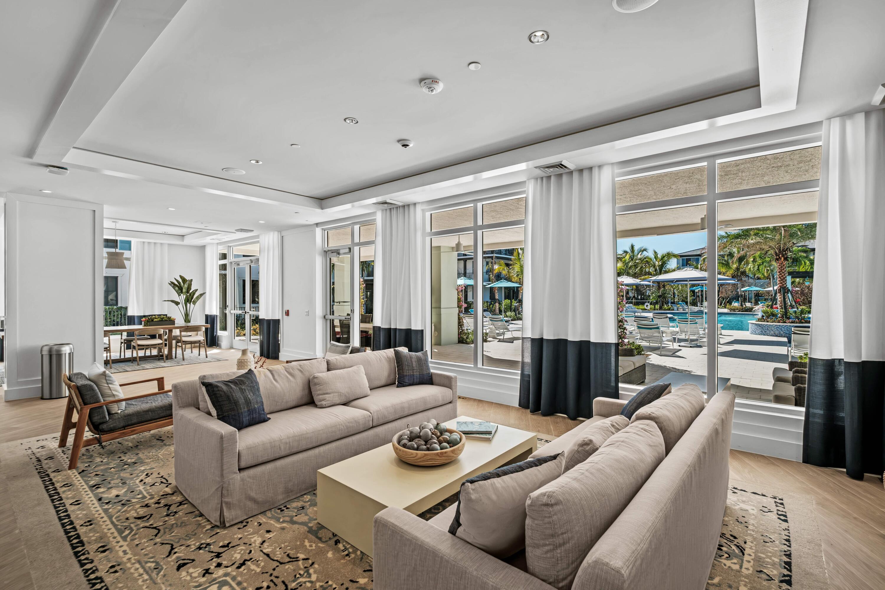 2000 Stirling Road, Unit 14103 Hollywood, FL 33020 - Photo 25 of 35 a living room with furniture and large windows