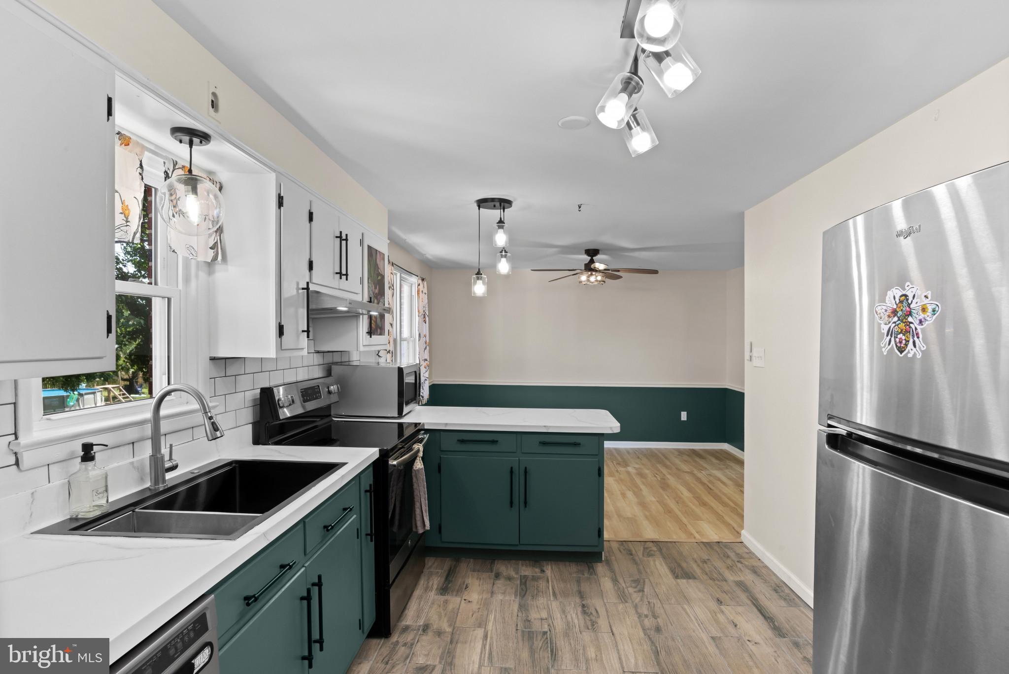 14 Sharon Road Enola, PA 17025 - Photo 12 of 40 Kitchen featuring white upper cabinetry, teal lowe