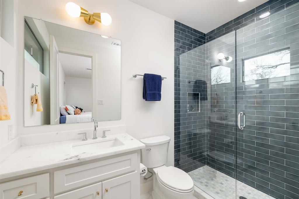 5019 Lark Lane Dallas, TX 75209 - Photo 18 of 32 a bathroom with a sink a toilet and shower