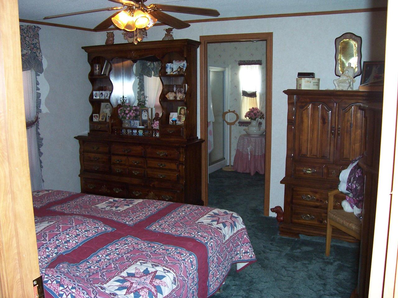 4619 Horseshoe Bend Road Goodview, VA 24095 - Photo 3 of 7 a bedroom with a bed and a mirror on dresser