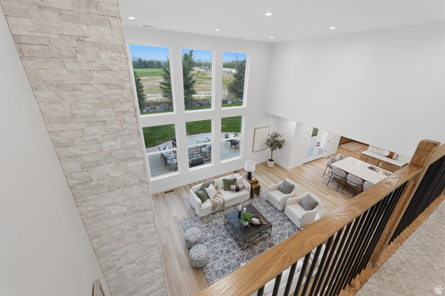 702 Alpine Highway Alpine, UT 84004 - Photo 40 of 83 Open-concept living area with a stone-clad accent wall, soaring ceilings, and expansive windows