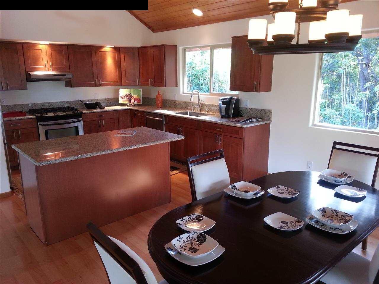 1450 Kauhikoa Road Haiku, HI 96708 - Photo 8 of 30 a kitchen with a refrigerator and a stove