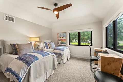 a bedroom with a bed and a window