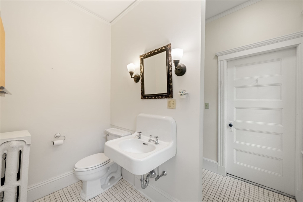 179 Rawson Road, Unit 2 Brookline, MA 02445 - Photo 18 of 42 a white toilet sitting next to a bathroom sink