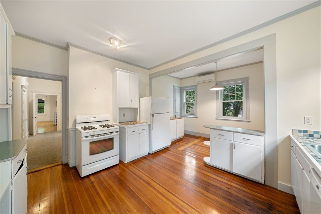 179 Rawson Road, Unit 2 Brookline, MA 02445 - Photo 23 of 42 a kitchen with stainless steel appliances granite countertop a stove a sink and a refrigerator