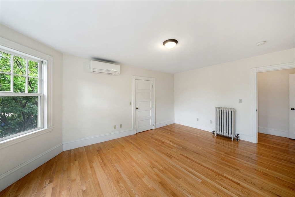 179 Rawson Road, Unit 2 Brookline, MA 02445 - Photo 29 of 42 a view of empty room with wooden floor and fan