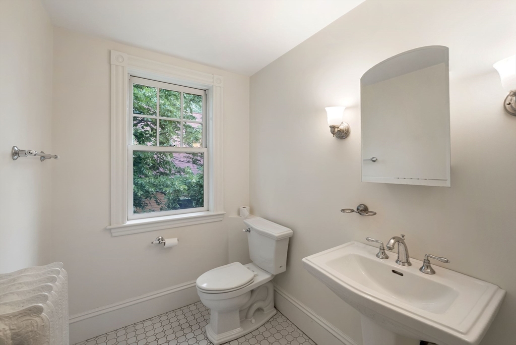 179 Rawson Road, Unit 2 Brookline, MA 02445 - Photo 34 of 42 a bathroom with a sink toilet and a mirror