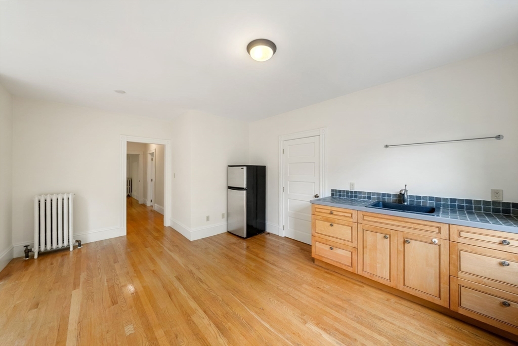 179 Rawson Road, Unit 2 Brookline, MA 02445 - Photo 36 of 42 a view of a kitchen with wooden floor