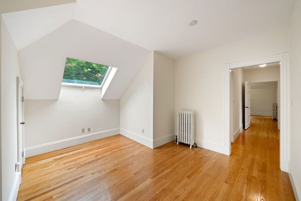 179 Rawson Road, Unit 2 Brookline, MA 02445 - Photo 38 of 42 wooden floor in an empty room with a window