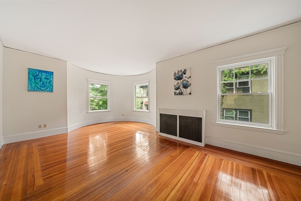 179 Rawson Road, Unit 2 Brookline, MA 02445 - Photo 6 of 42 an empty room with windows and fireplace
