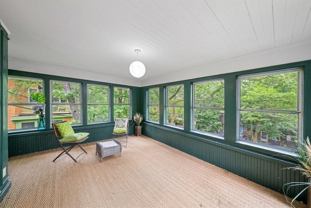 179 Rawson Road, Unit 2 Brookline, MA 02445 - Photo 8 of 42 a living room filled with furniture and a large window
