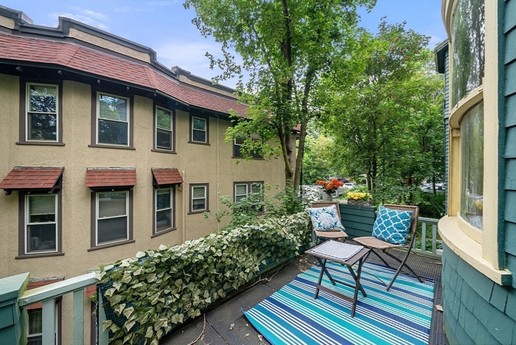 179 Rawson Road, Unit 2 Brookline, MA 02445 - Photo 10 of 42 a front view of a house with a garden
