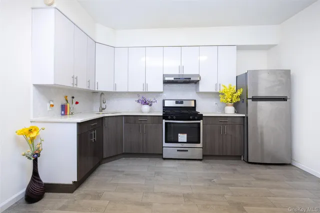 a kitchen with stainless steel appliances a refrigerator sink and cabinets