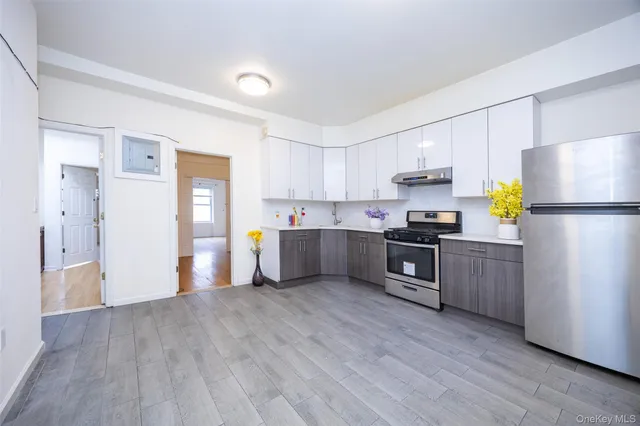 a kitchen with a refrigerator a microwave and cabinets