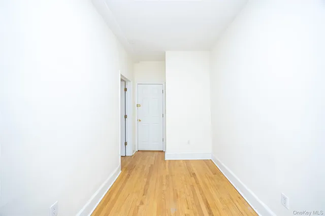 a view of a room with wooden floor and a bathroom