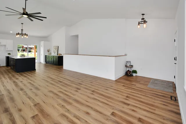 a kitchen with a sink window and cabinets