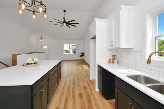 a kitchen with a sink and large window