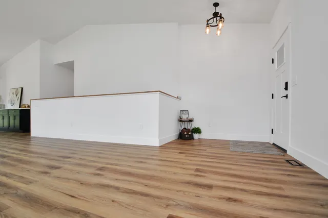 a view of a hallway view with wooden floor and staircase