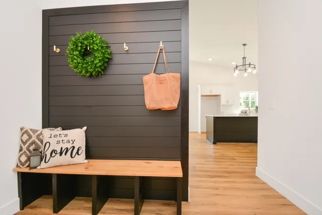 a view of a hallway with wooden floor and entryway