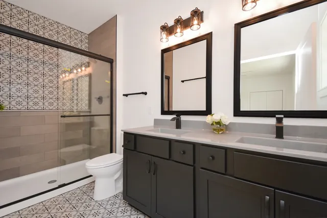 a bathroom with a sink mirror vanity and toilet