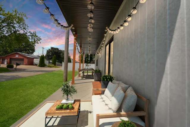 a view of yard from deck with patio