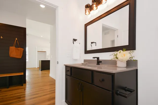 an empty room with a kitchen area and white walls