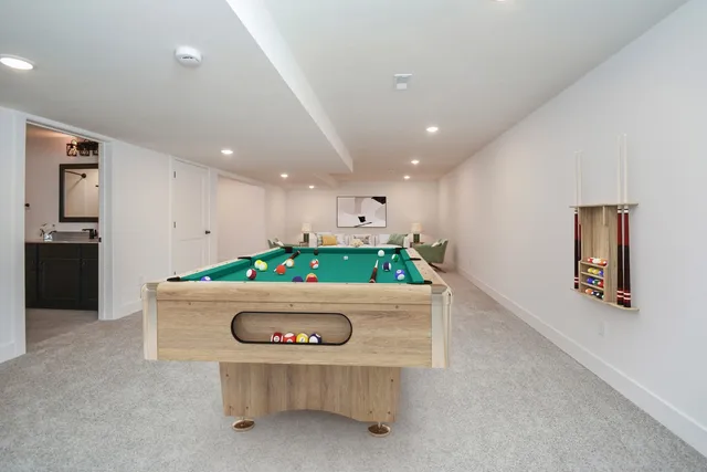 a kitchen with a sink a counter top space and living room area