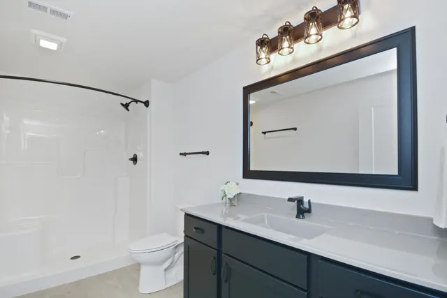 a kitchen with stainless steel appliances granite countertop a sink cabinets and wooden floor