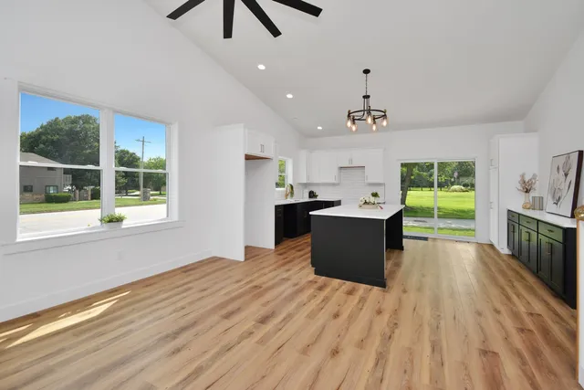 a view of a hallway with wooden floor and a potted plant