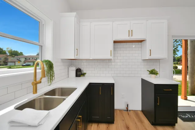 a front view of a house with yard and green space