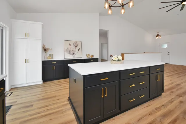 a kitchen with stainless steel appliances granite countertop a refrigerator and a sink