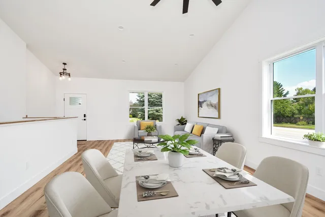 a view of empty room with wooden floor and window