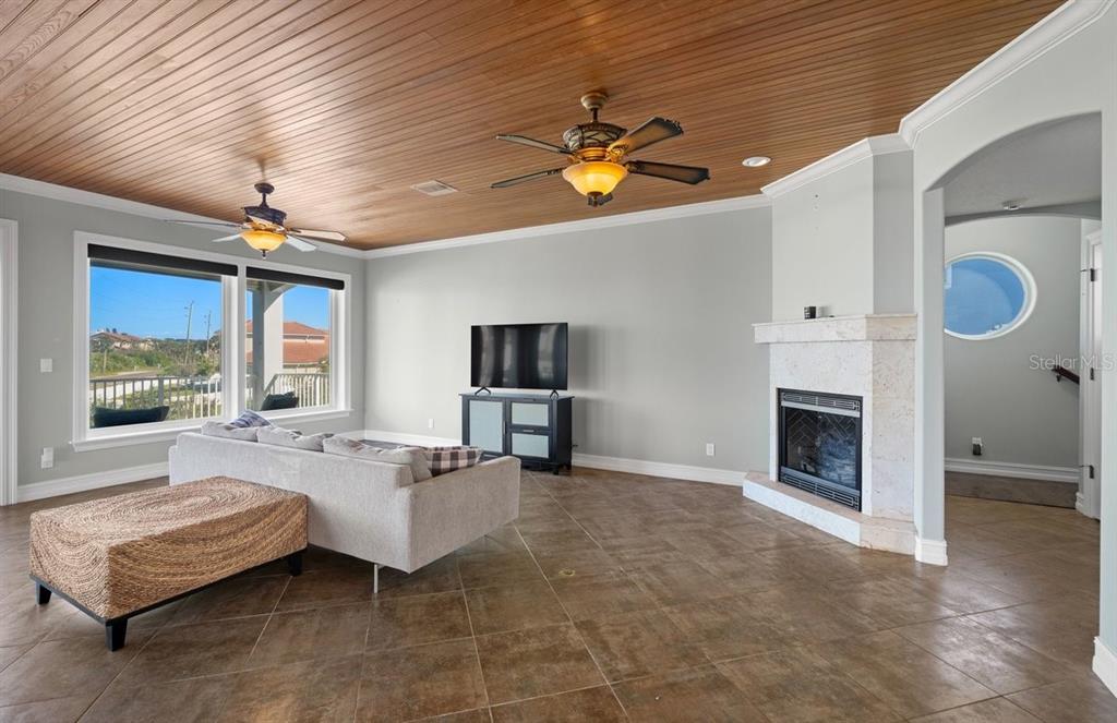 2 Mar Azul North Ponce Inlet, FL 32127 - Photo 18 of 98 a living room with furniture a fireplace and a flat screen tv