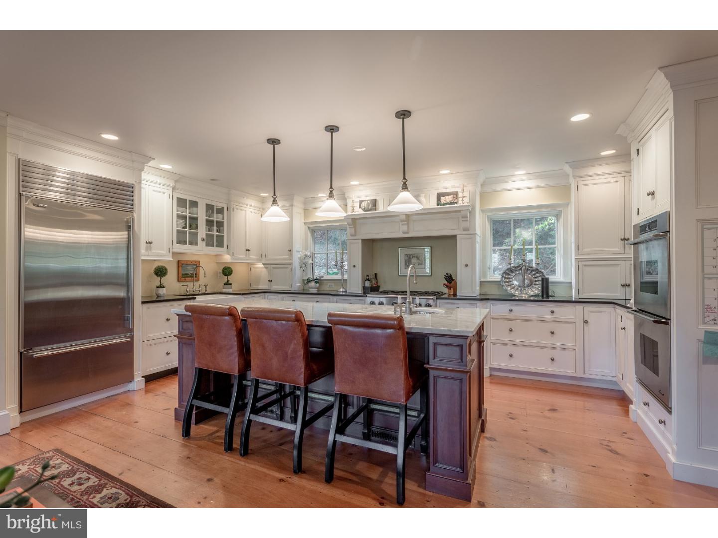 7174 Centerbridge Road New Hope, PA 18938 - Photo 12 of 24 a kitchen with stainless steel appliances granite countertop a kitchen island a stove a table and chairs