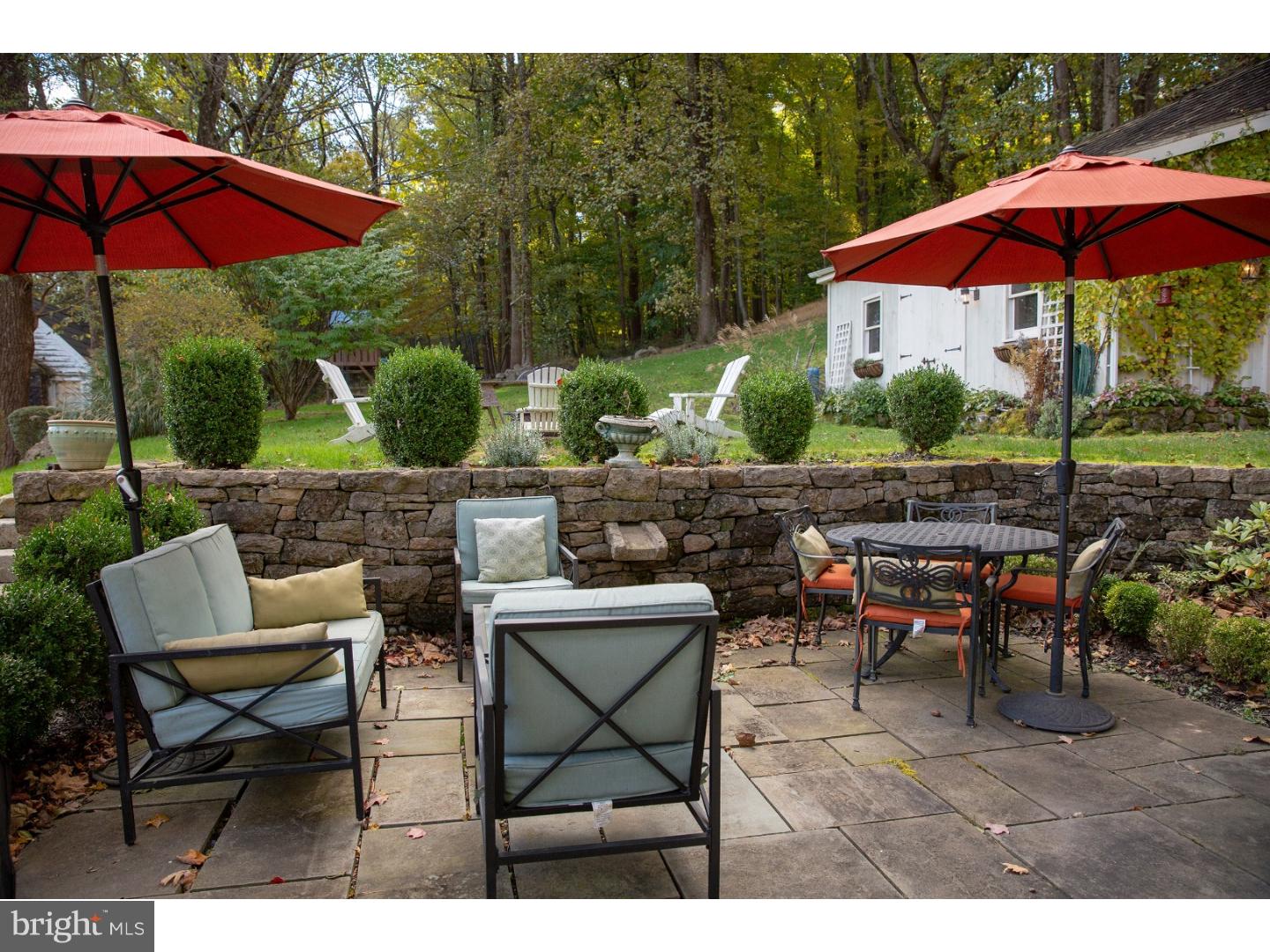 7174 Centerbridge Road New Hope, PA 18938 - Photo 5 of 24 a view of patio with chairs and table under an umbrella