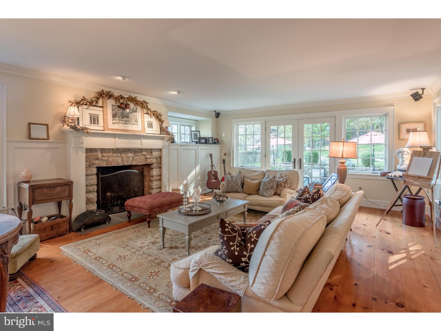 7174 Centerbridge Road New Hope, PA 18938 - Photo 9 of 24 a living room with furniture large window and a fireplace