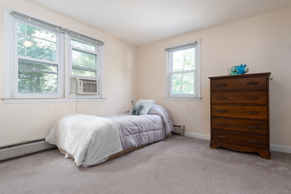 22 Leigh Road Wenham, MA 01984 - Photo 15 of 28 a spacious bedroom with a bed and a dresser