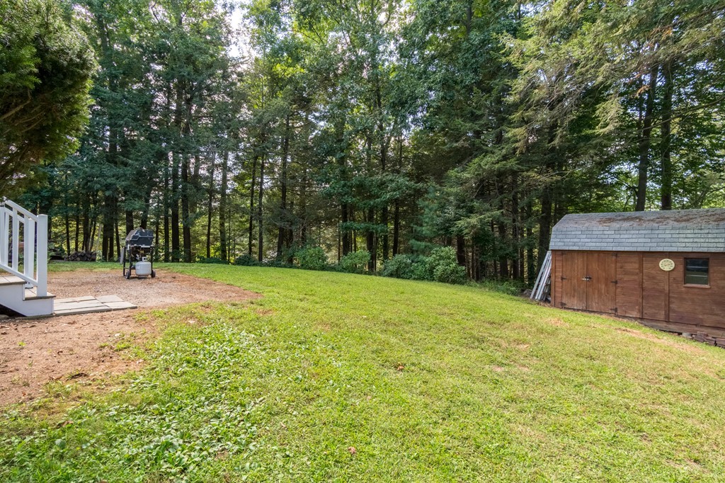 22 Leigh Road Wenham, MA 01984 - Photo 21 of 28 a view of a backyard with a small cabin
